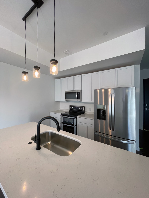 Forte Condos Pittsburgh - Kitchen interior white cabinets stainless appliances kitchen island